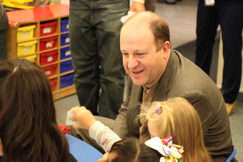 Governor Jared Polis chats with children at Littleton's Village preschool on Jan. 17. Polis and two state lawmakers visited the school to meet with Littleton Public Schools officials about a proposed expansion of preschool access.